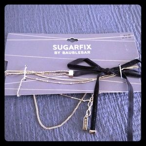 Sugarfix BaubleBar gold choker with a bow.
